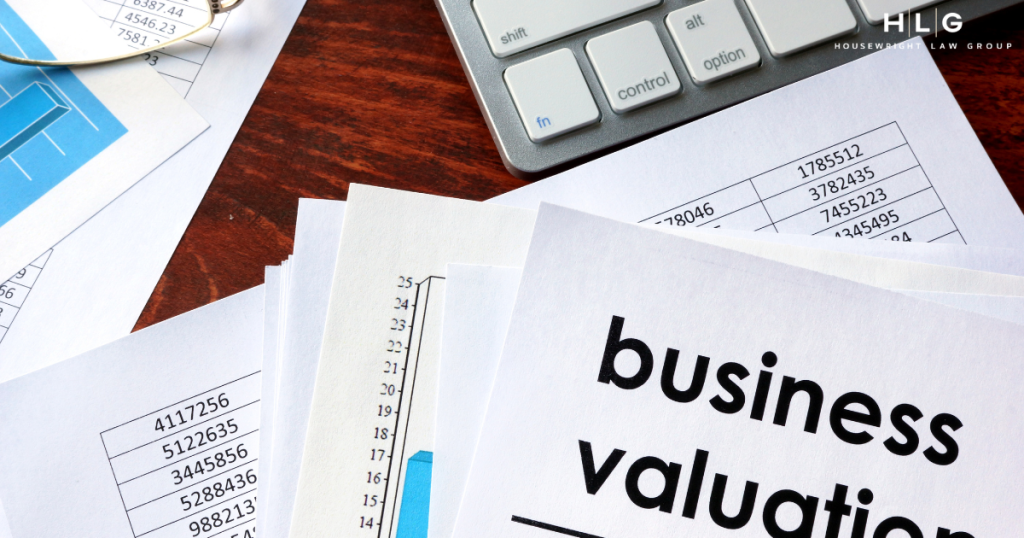 Business valuation documents and keyboard illustrating financial asset division in Texas divorce.